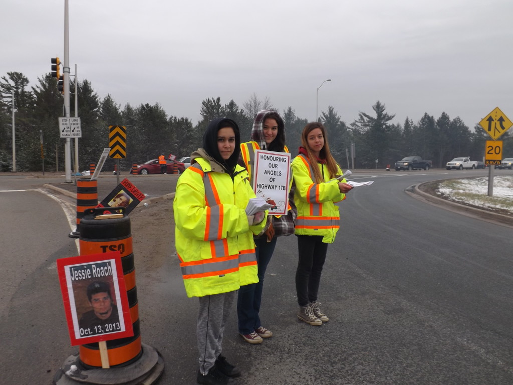 Pictured left to right, Selina Nolan, Jamie Mader, Sara Nolan. Cheered by the greater number of motorists honking, waving and rolling down windows to accept information pamphlets, though these young ladies were not spared a handful of scowling faces and at least one older woman flipping them the bird (while I was there).